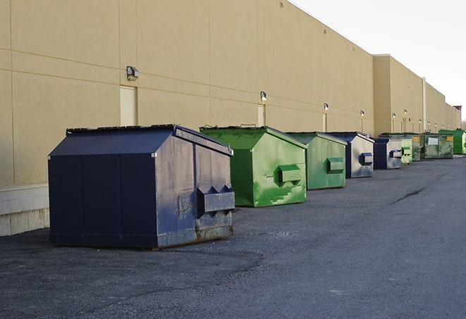 a yellow construction dumpster filled with waste materials in Leesburg